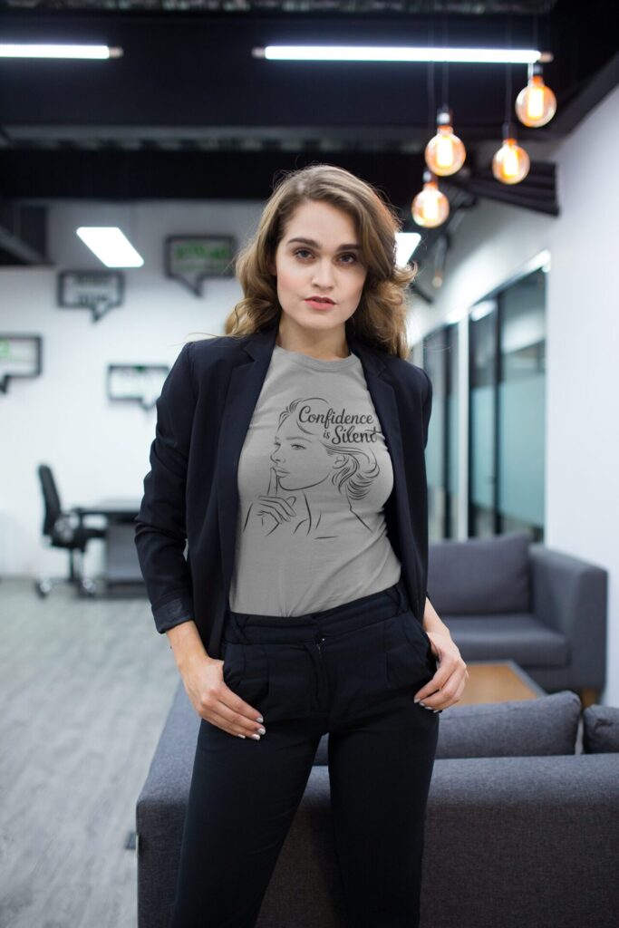 How Motivational T-Shirts Inspire Confidence Daily (+ Outfit Ideas) | Empowering T-Shirts by Quotnair beautiful woman wearing a t shirt mockup and a jacket while at the office a20529 1 | Empowering T-Shirts by Quotnair
