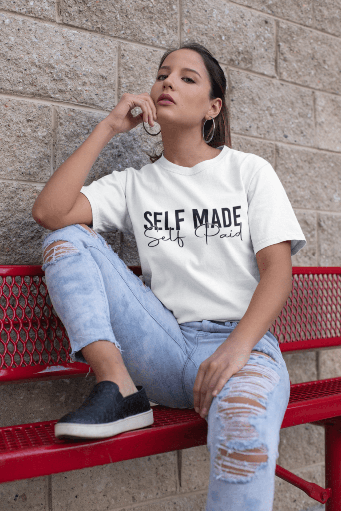 How Motivational T-Shirts Inspire Confidence Daily (+ Outfit Ideas) | Empowering T-Shirts by Quotnair mockup of a trendy woman wearing a unisex tee and distressed jeans 23038 | Empowering T-Shirts by Quotnair