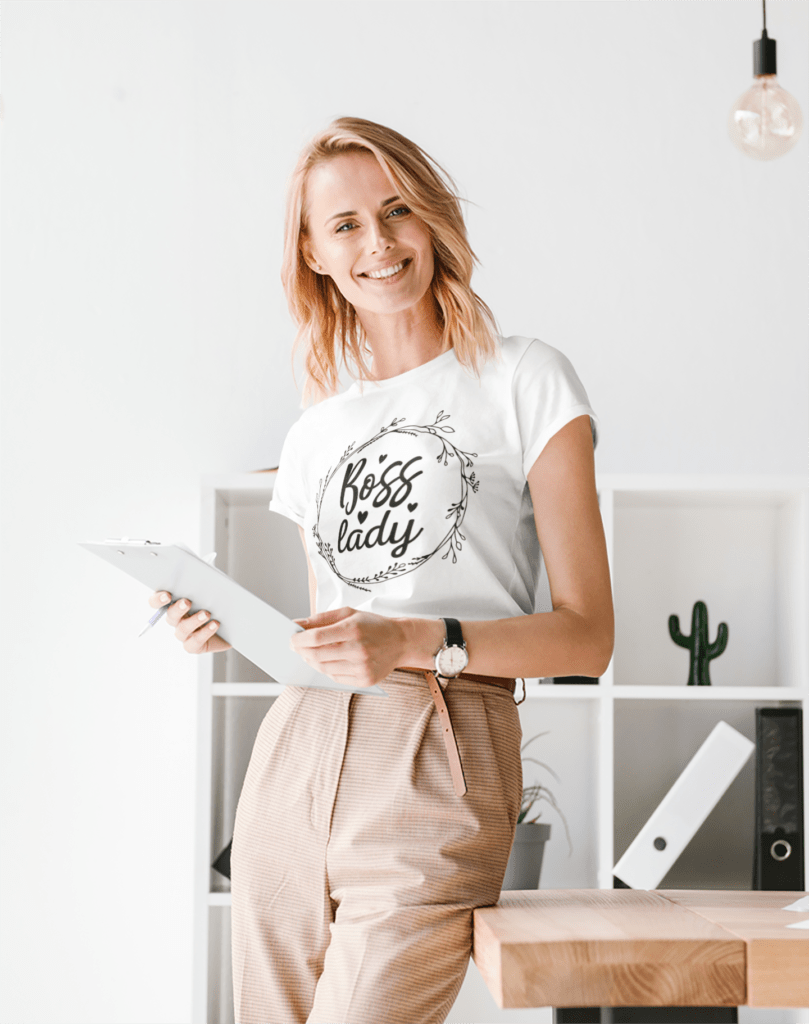 How Motivational T-Shirts Inspire Confidence Daily (+ Outfit Ideas) | Empowering T-Shirts by Quotnair t shirt mockup featuring a woman posing at a minimalist office 37658 r el2 | Empowering T-Shirts by Quotnair