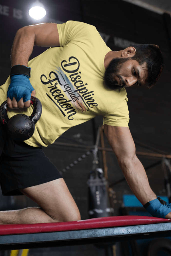 How Motivational T-Shirts Inspire Confidence Daily (+ Outfit Ideas) | Empowering T-Shirts by Quotnair tee mockup of a muscular man training at the gym 26251 | Empowering T-Shirts by Quotnair